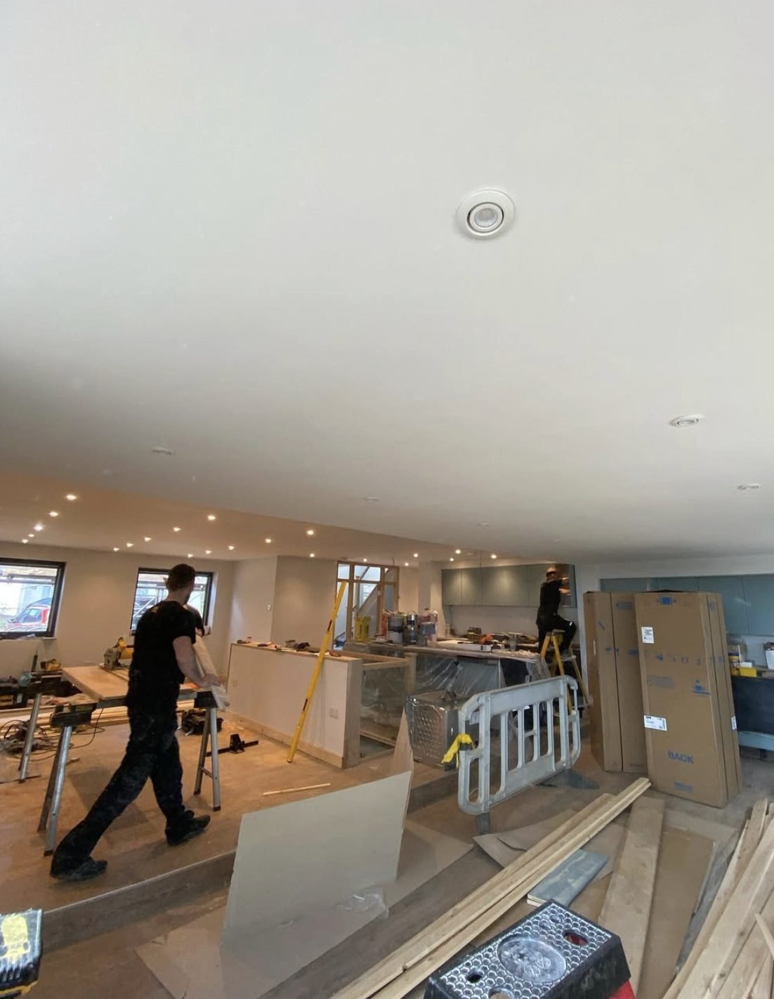 Recessed downlights installed across a new open-plan ceiling